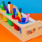 Art Station with its four organizer cups full of markers and paint sticks